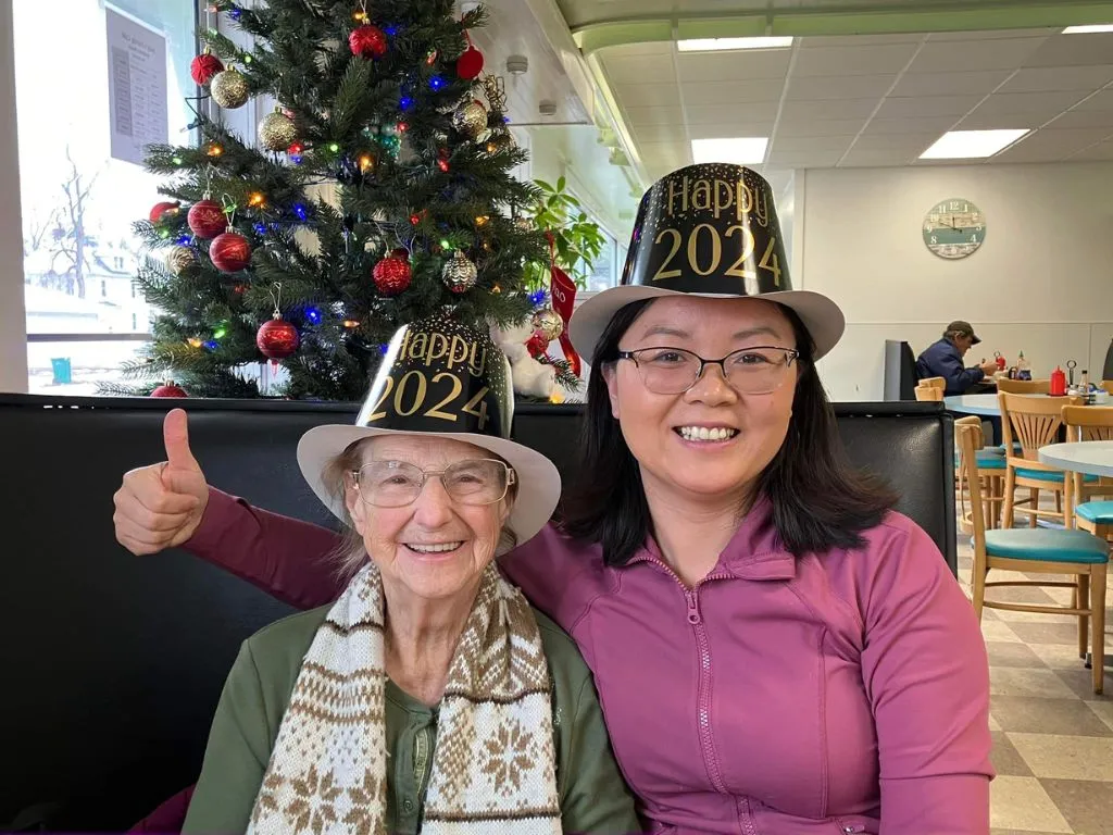 judy and elderly woman with new years hats