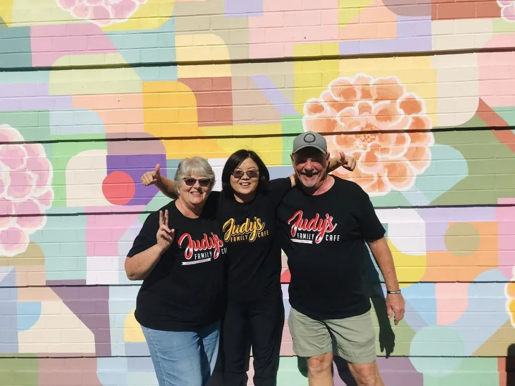 judy with friends by colorful wall