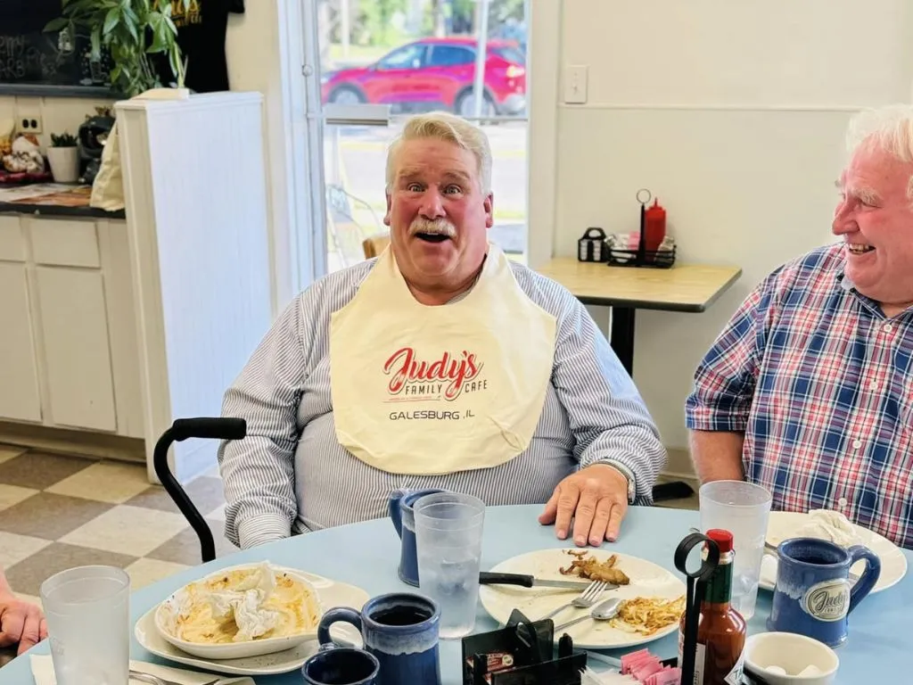 older man with judys cafe bib